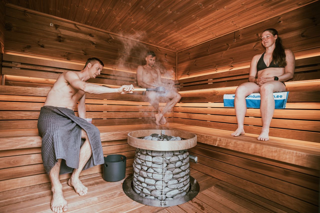 services-02 Three people enjoying a steamy sauna session, embracing wellness and relaxation.