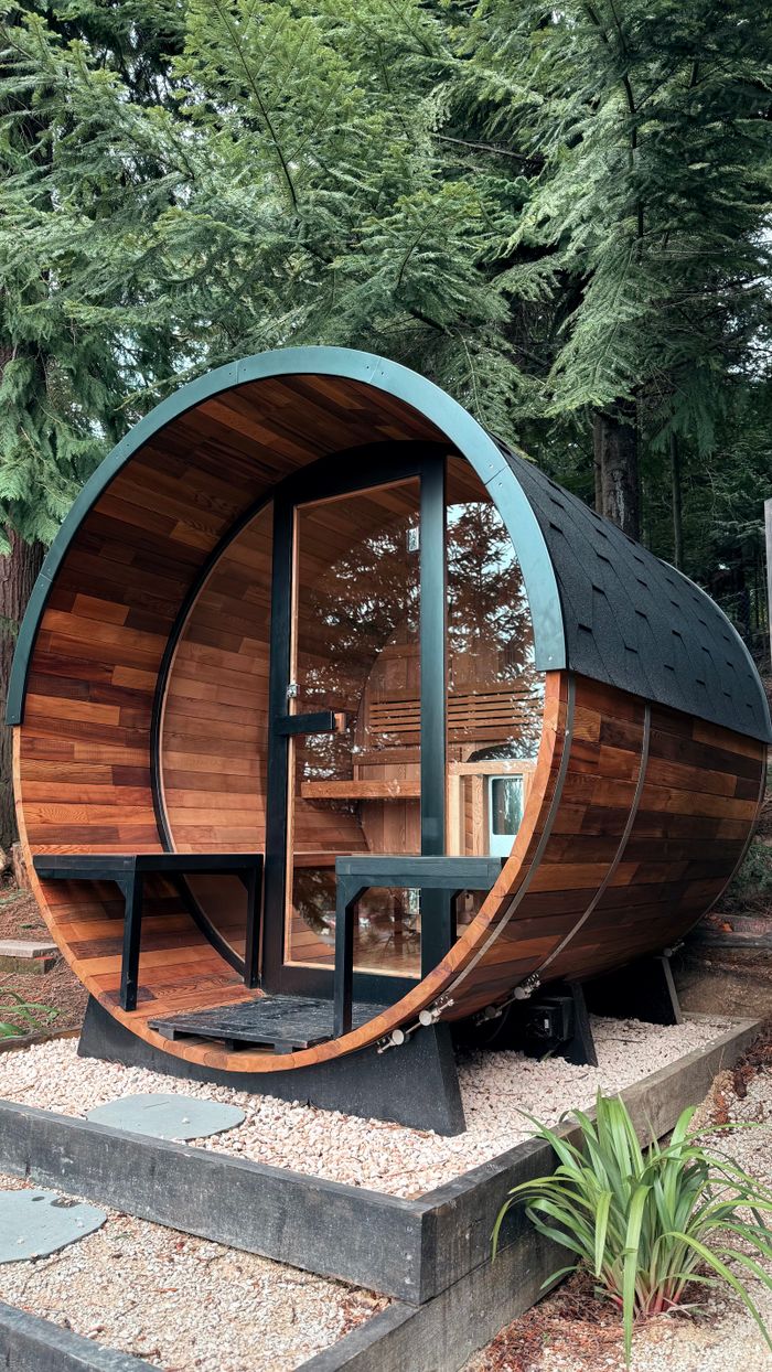 services-01 Rustic wooden barrel sauna located in serene forest of Hanmer Springs, New Zealand.